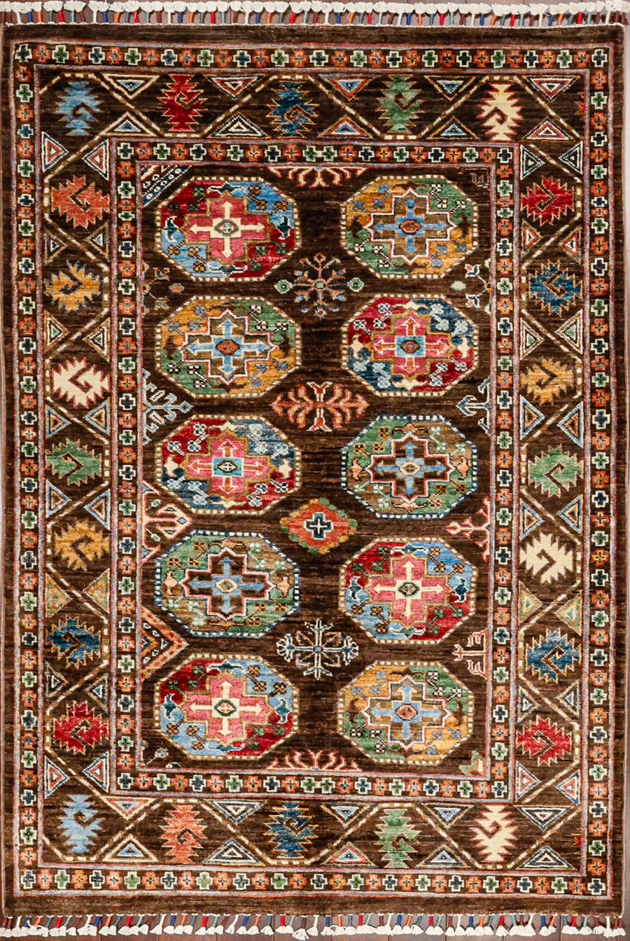 A colorful version of the classic Bokhara pattern hand-knotted in wool and made in Pakistan. The smaller area rug features a colorful assortment of tribal octagonal shapes in jewell tones against a brown background.  