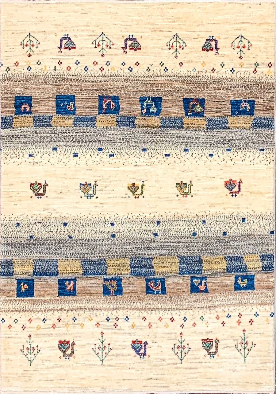 Tribal Hand-knotted Gabbeh made using natural wool tones and featuring peacocks and plants among blue squares.