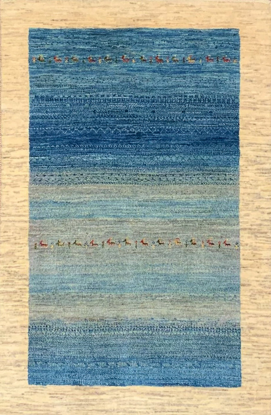 Handmade Gabbeh Rug from Southern Iran featuring a blue central field framed by a thick border of undyed wool. 