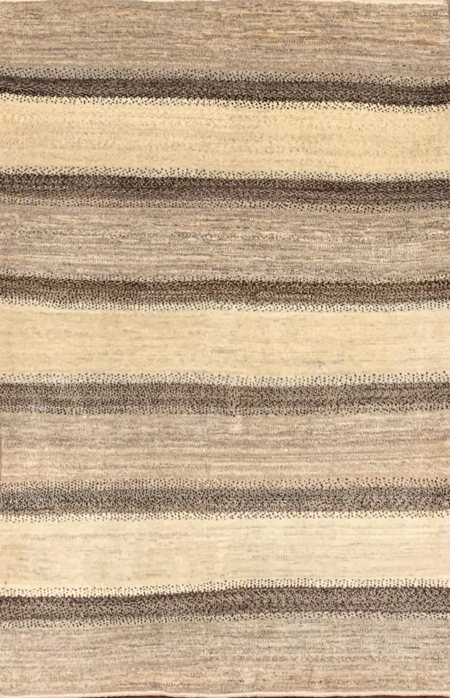 Handmade Persian Gabbeh featuring alternating stripes of natural wool tones 