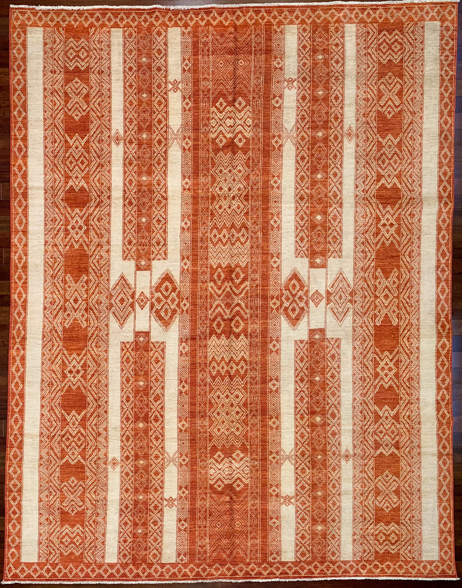 Tribal 9x12 rug in red and white with strong pattern.