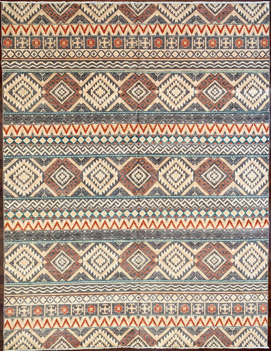 Tribal rug from Afghanistan made with wool. Reds, golden yellows. greens, and grey colors in southwest style design