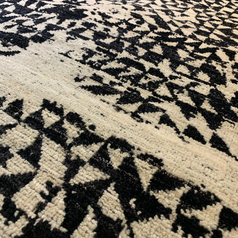 Detail of Pattern Mix 5 from Battilossi Rugs. Handwoven 8x10 wool rug in light beige and black pattern of triangles. 
