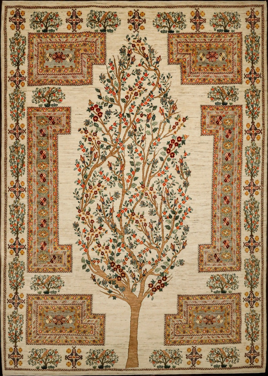 Classic and traditional handmade Persian area rug featuring tree of life and floral border of green, red, orange tones. 