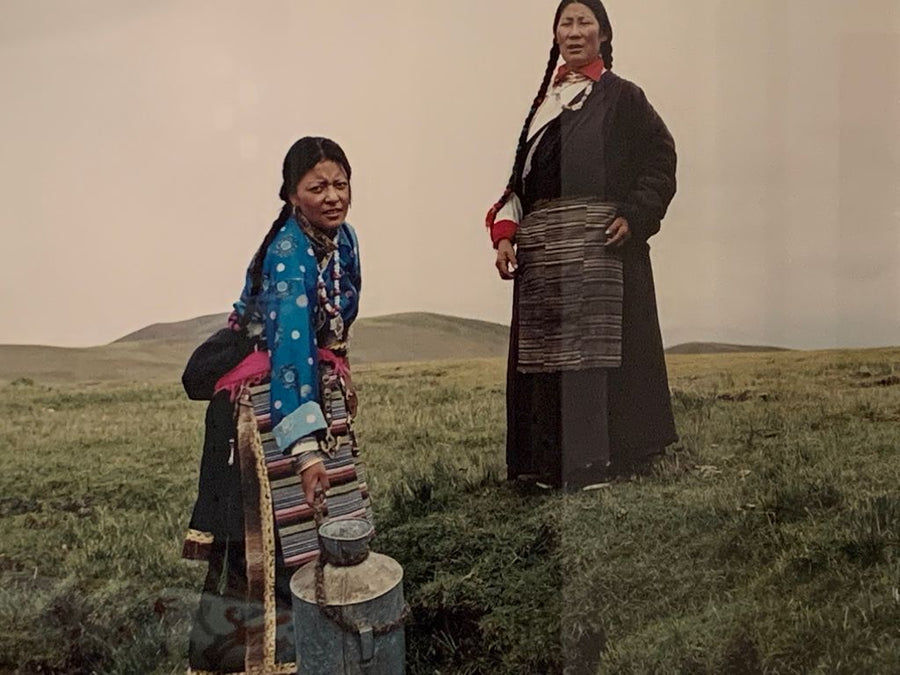 Tibetan Women wearing traditional striped aprons in a field 