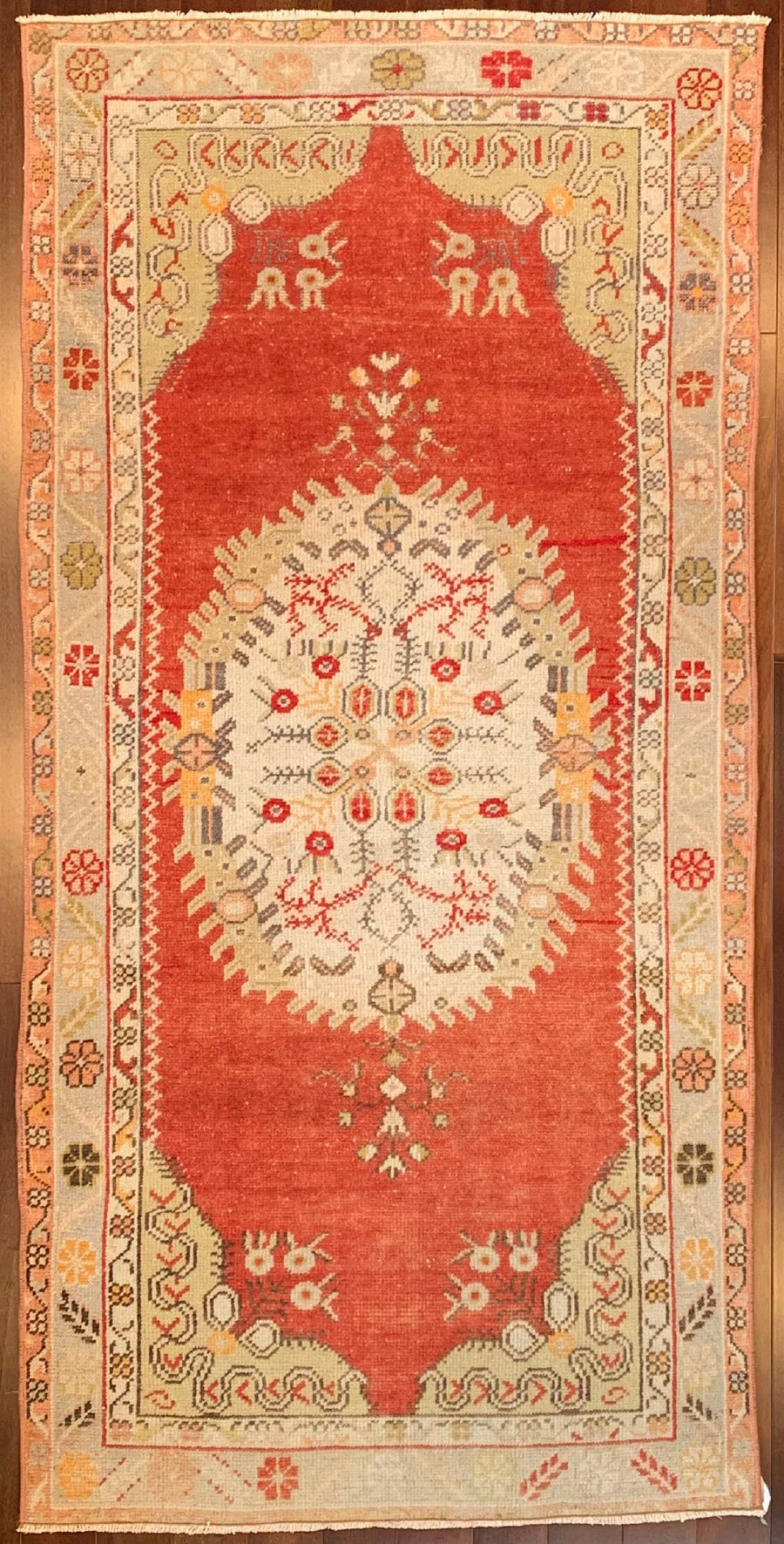 classic Turkish rug with gold border and center medallion