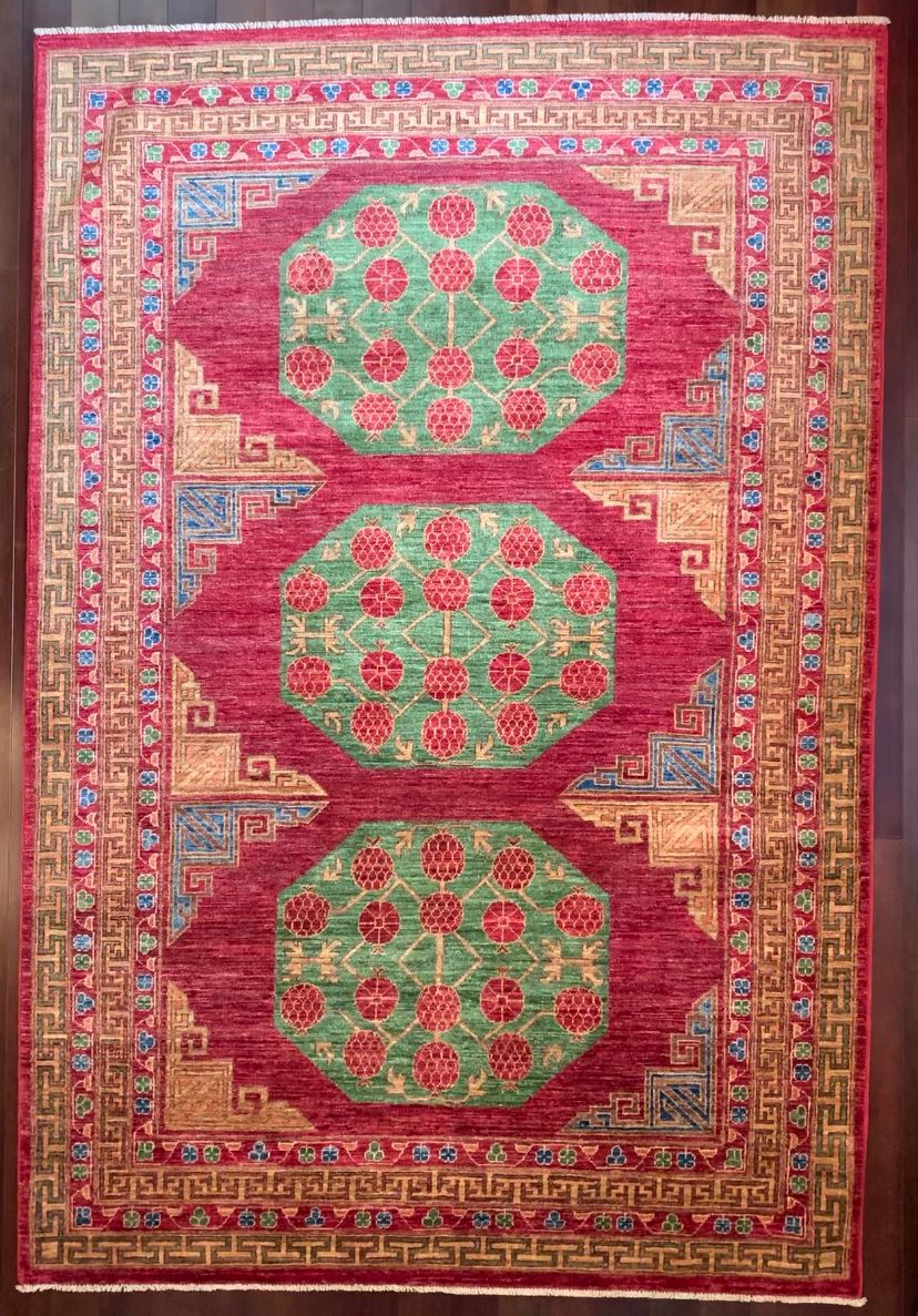 Khotan Style red and green rug with pomegranates in red